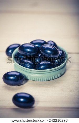 Cod liver oil omega 3 gel capsules isolated on wooden background. Vitamin D capsuls.  dietary supplement