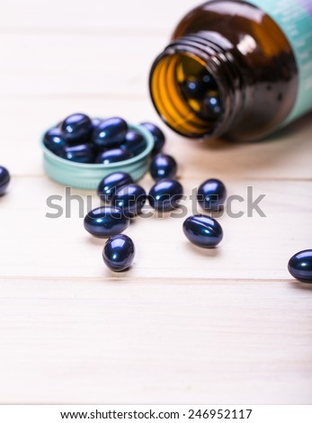 Cod liver oil omega 3 gel capsules isolated on wooden background. Vitamin D capsules. dietary supplement