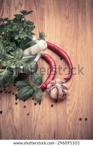 bunch of fresh organic basil in olive cutting board on rustic wooden background