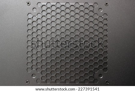 Black painted metal with hexagonal holes. Photo front.