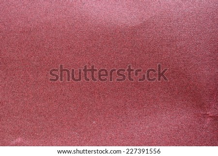 Red sandpaper for polishing and surface treatment.