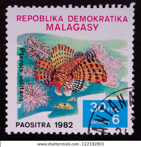 REPULIC OF MADAGASCAR - CIRCA 1982: A stamp printed in  Republic of Madagascar shows a orange fish in the sea, circa 1982.