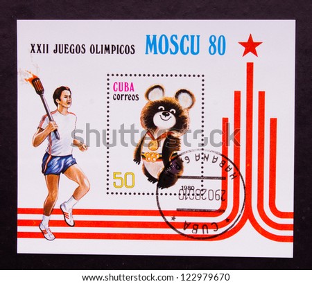CUBA - CIRCA 1980: A stamp printed in Cuba shows an olympic player with the fire and olympic emblem-bear, circa 1980.