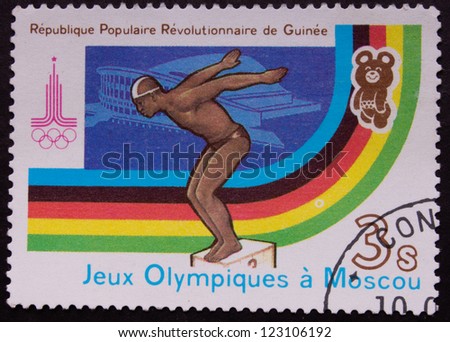 REPUBLIC OF GUINEA- CIRCA 1980: A stamp printed in Republic of Guinea shows a swimmer in the moment of jumping, circa 1980.