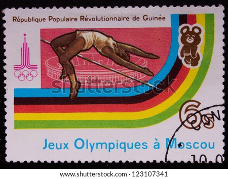 REPUBLIC OF GUINEA - CIRCA 1980: A stamp printed in Republic of Guinea shows a high jumper doing his exercize in olympic games, circa 1980.