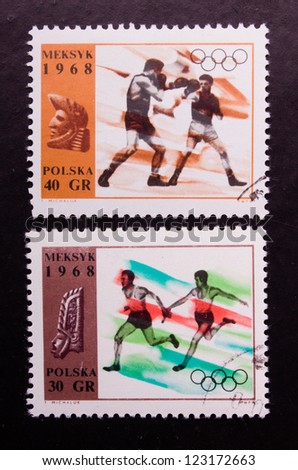 POLAND - CIRCA 1968: A stamp printed in Poland shows the olympic boxers and runners, circa 1968.