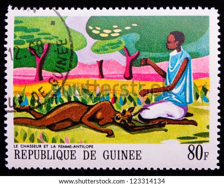 GUINEA - CIRCA 1968: A stamp printed in Guinea shows an african legend with the images of a black boy and a black antelope woman , circa 1968.