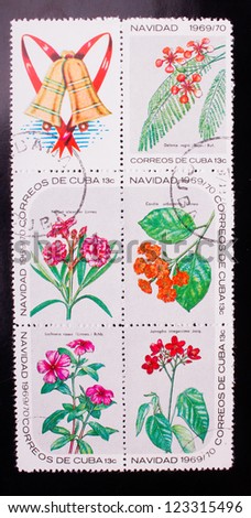CUBA - CIRCA 1969: A stamp printed in Cuba shows five kinds of red and pink flowers , circa 1969.