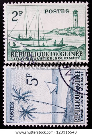 GUINEA - CIRCA 1959: A stamp printed in Guinea shows two ports with a lighthouse,boats and palms , circa 1959.