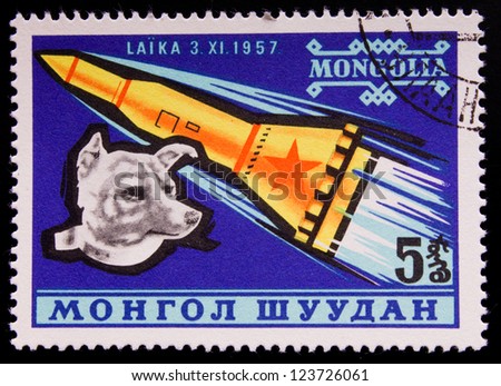MONGOLIA - CIRCA 1957: A stamp printed in Mongolia shows a flying rocket and a dog, circa 1957.