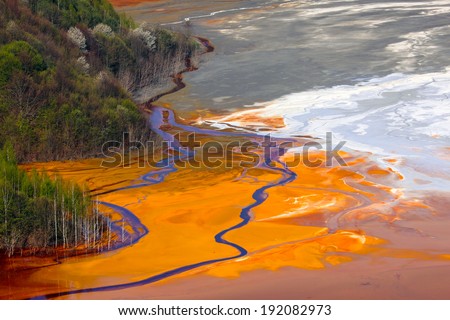Polluting substances used for gold and copper mining create painting-like colors from  mixing in a sterile lake.