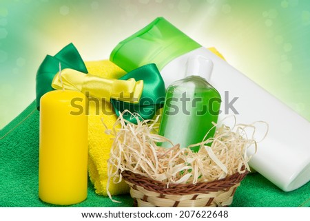 Cosmetics as a gift: composition with different cosmetic products for body care, wicker, candle, towels, bow
