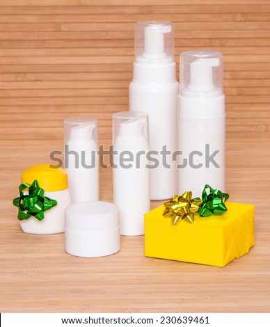 Cosmetics as a gift: different cosmetic products for body care and gift box decorated with small bows