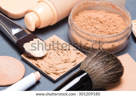 Set of makeup products and accessories to even out skin tone and complexion. Shallow depth of field