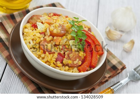 Lentils with vegetables in a bowl on a wooden table