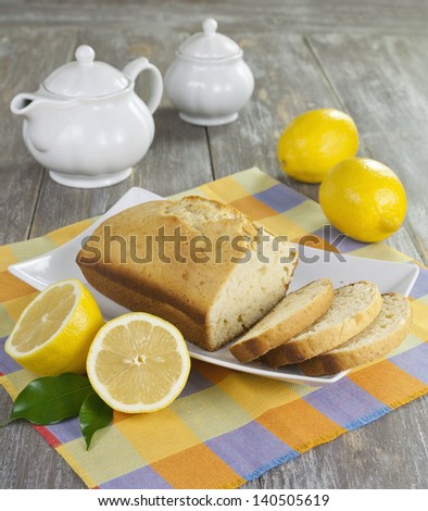 Lemon cake and lemons on a wooden table