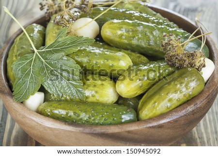 Pickles in a wooden bowl on the table