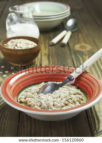 Porridge in orange bowl on the table