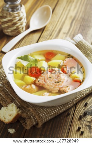 Fish soup in a square bowl on the table