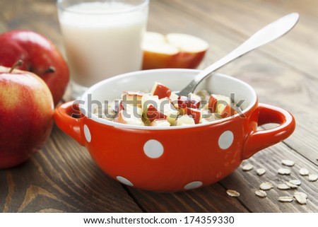 Oatmeal with caramelized apples in the orange bowl