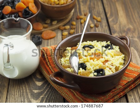 Millet porridge with dried apricots and prunes in a bowl