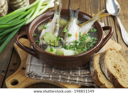 Homemade soup of river fish in the bowl on the table