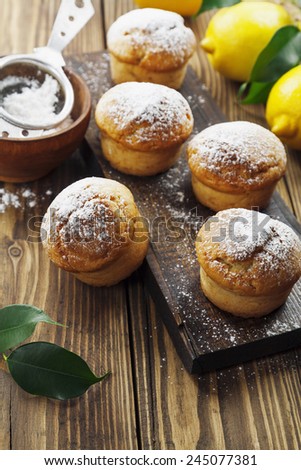 Lemon muffins with sugar powder on the wooden table