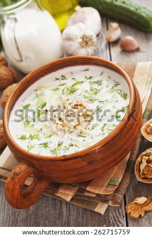 Tarator, bulgarian sour milk soup in an orange bowl