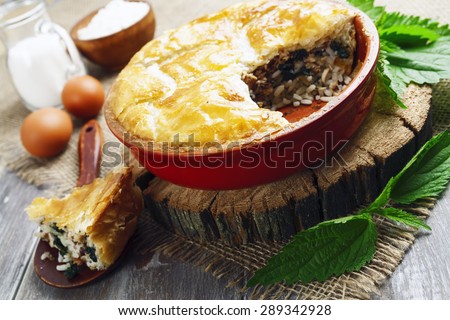 Pie nettles, rice and canned fish on the table