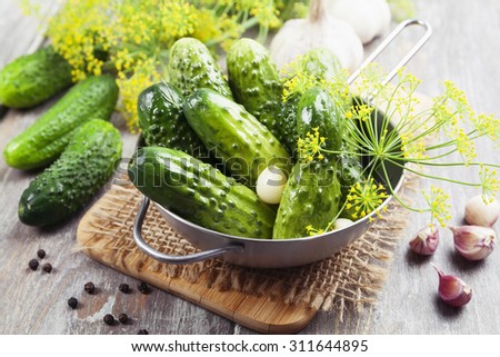 Canned cucumbers in a metal pan on the table