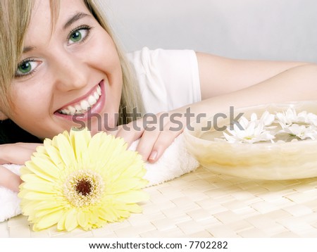Close up of beautiful face and bowl full of flower