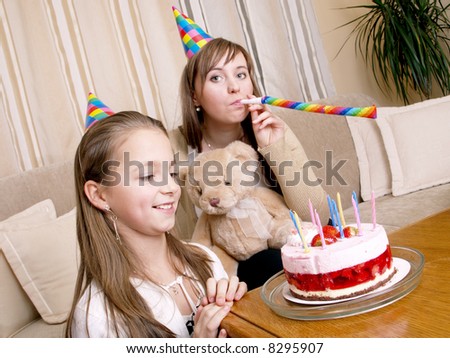 mother with daughter and birthday cake