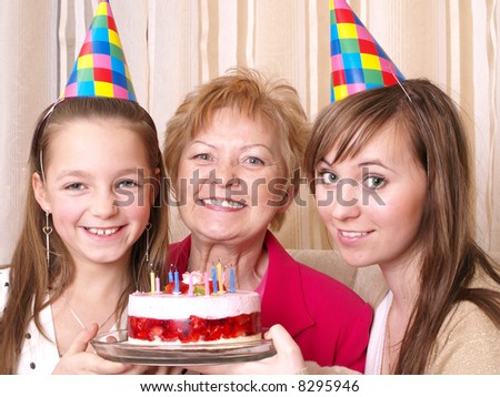 Daughter, mother and grandmother with birthday cake