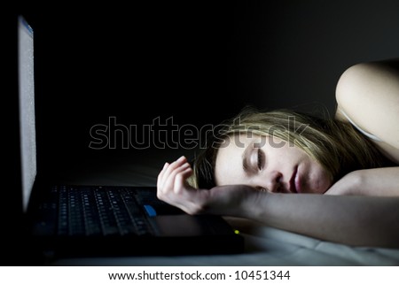 Young woman takes a break and sleeps on the couch, front of her laptop