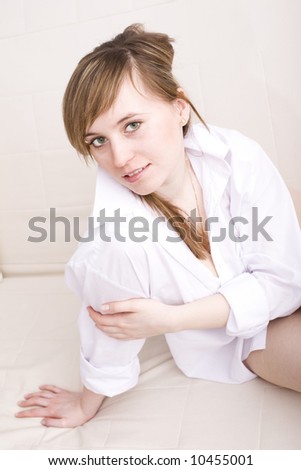 Lazy day. Beautiful young woman relaxing on bed