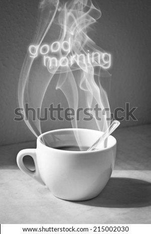 Cup of coffee with steam and good morning text