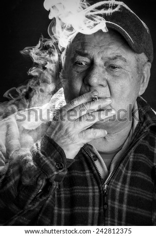 Black and white portrait of old man, smoking