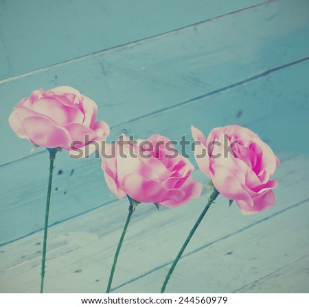 Vintage roses decoration on blue wood background, instagram style
