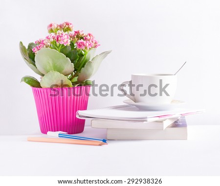 Workplace with flower books and a coffee cup with