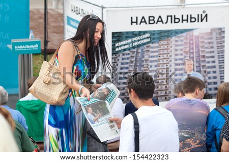 MOSCOW-AUGUST 23: An unidentified young women distributes newspapers on campaign for candidate for mayor of Moscow Alexey Navalny, 2013 in Moscow