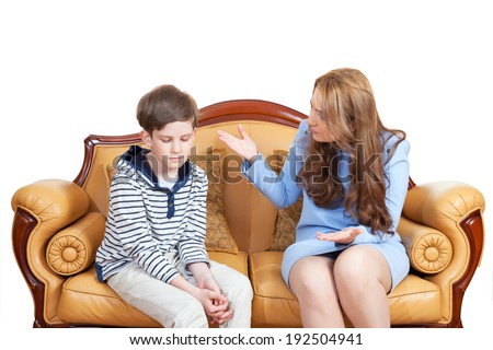 young mother scolds son, sitting on the sofa