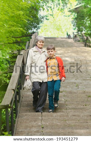 grandma and grandson go down the stairs