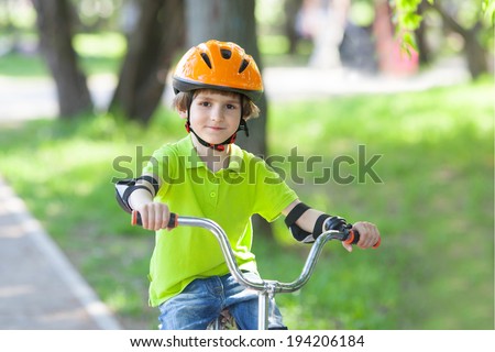 boy in a safety helmet rides a Bicycle on a Bicycle tracks