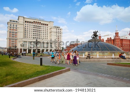 MOSCOW, RUSSIA- MAY 23, 2014: The group of graduates of school at Manezhnaya Square in day of \