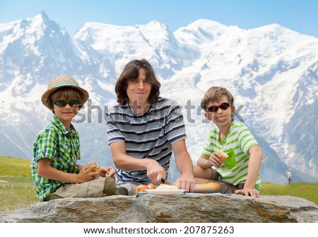 The trio (father and two sons) have got picnic against Mont Blanc massif.