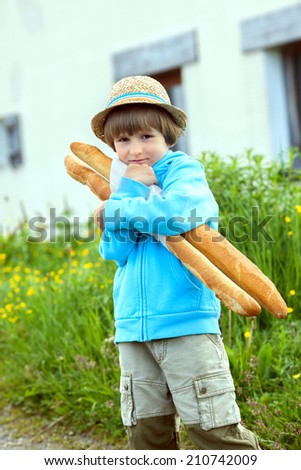 the boy with two baguettes on the street