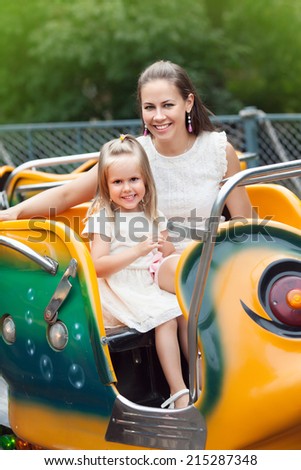 The mother and daughter in amusement park