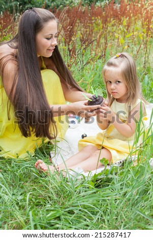 The small attractive girl and her mother with chocolate cake