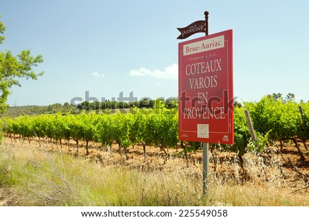 PROVENCE, FRANCE - JUNE 21, 2014: The vineyard of Varois in Provence with red information billboard.