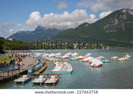 ANNECY, FRANCE - JUNE 26, 2014: Annecy lake in Napoleon III quay with walk way and boat landing stage